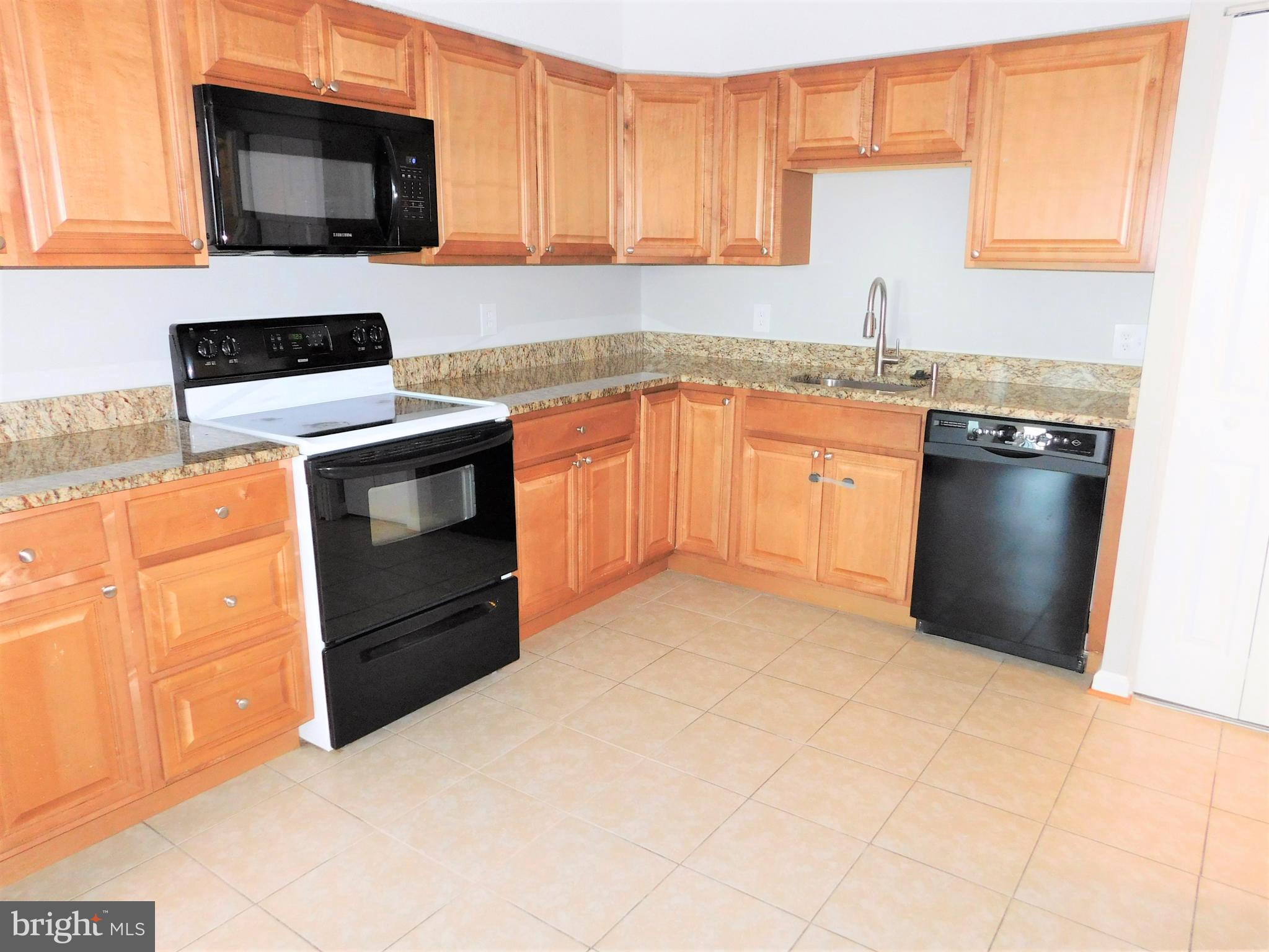 5501 Seminary Road, Unit 1006S Falls Church, VA 22041 - Photo 14 of 31 a kitchen with stainless steel appliances granite countertop a stove a sink and a microwave