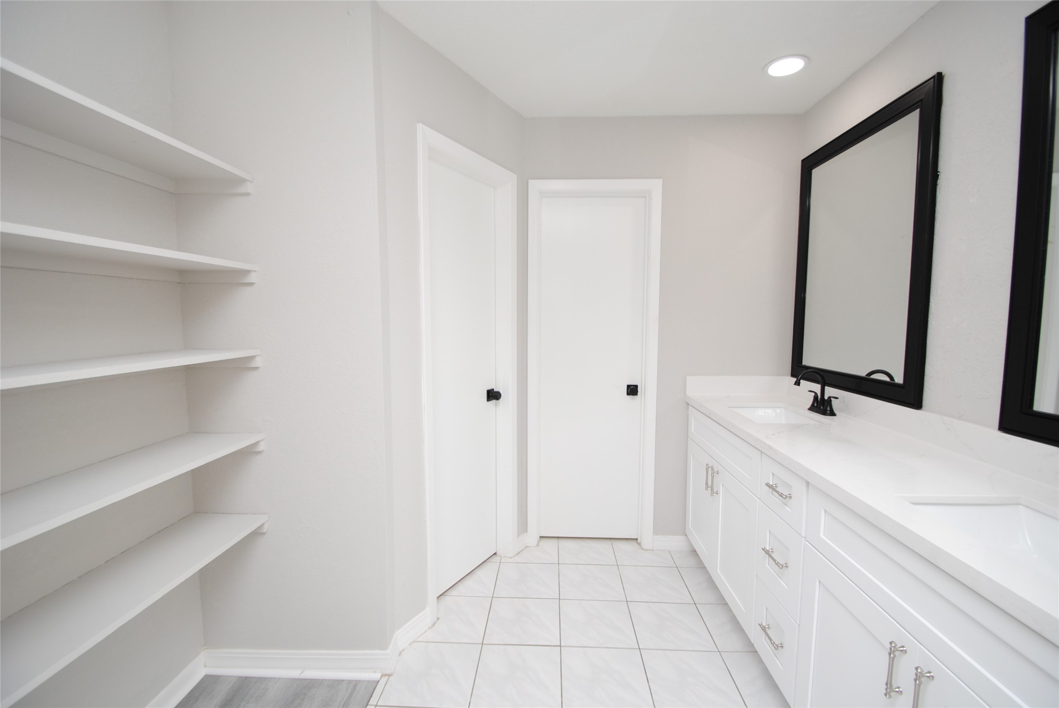 22831 John Rolfe Lane Katy, TX 77449 - Photo 22 of 34 a bathroom with a double vanity sink and mirror
