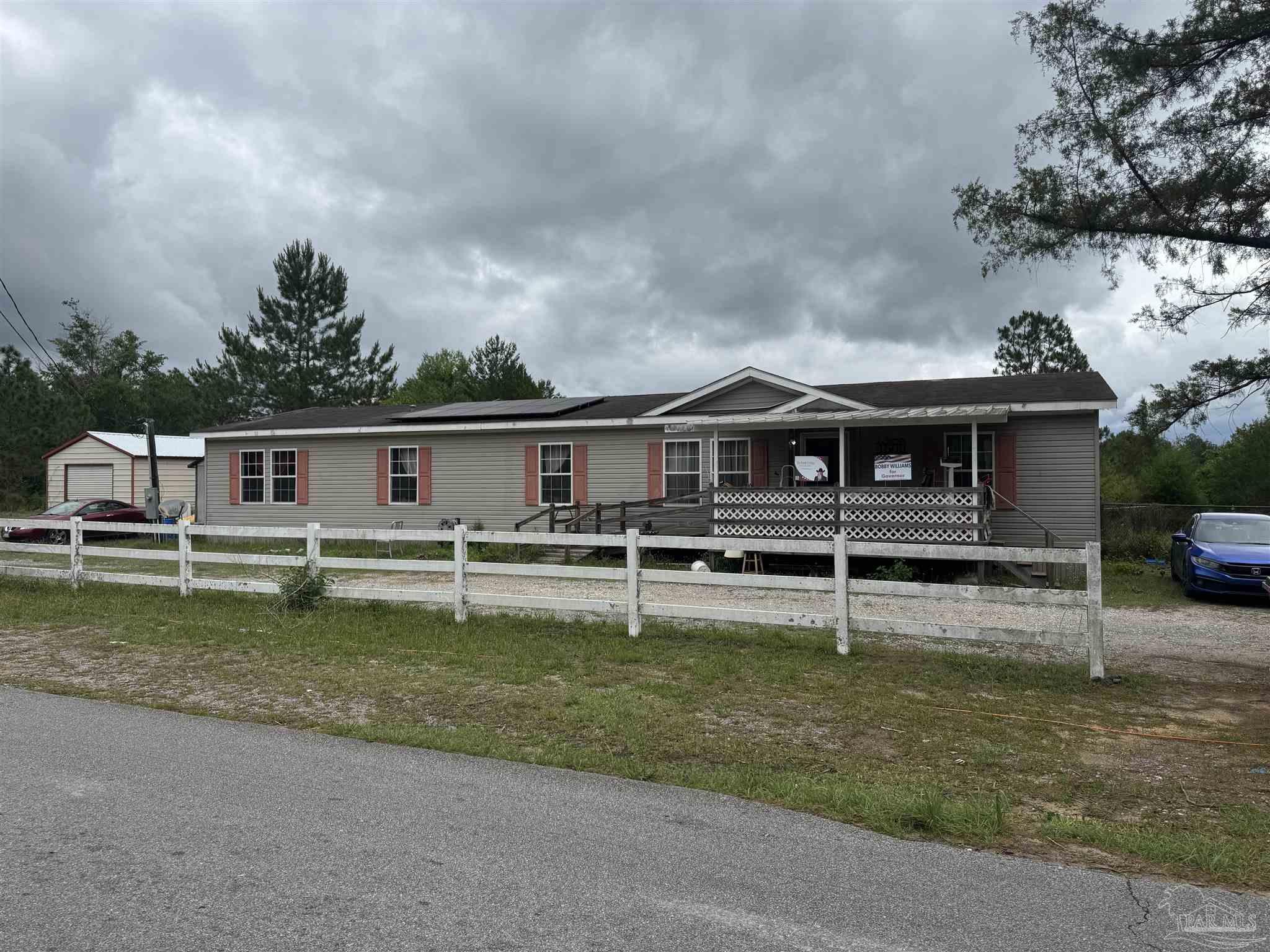 4508 Farm Life Road Milton, FL 32583 - Photo 1 of 20 a front view of a house with a yard