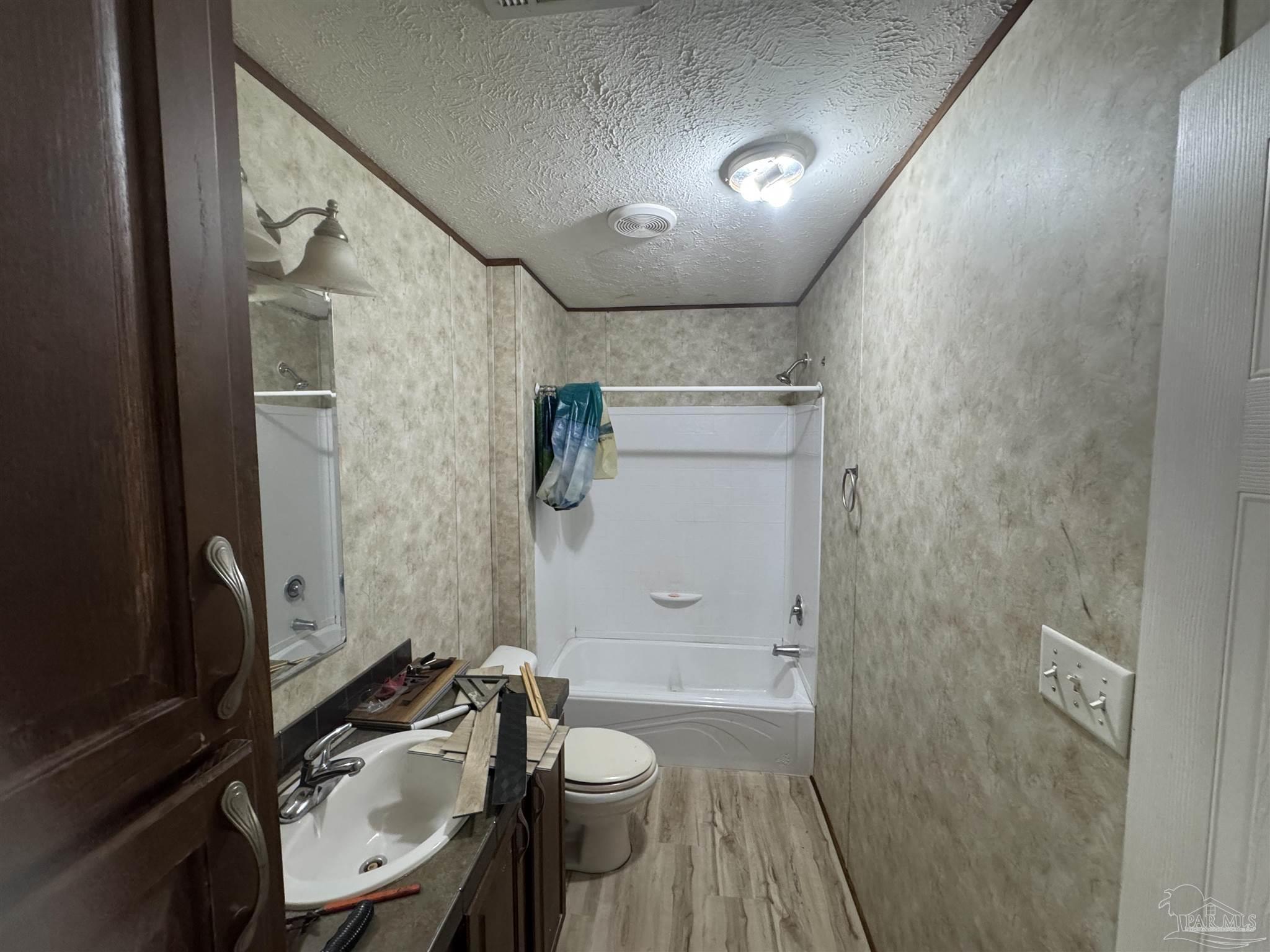4508 Farm Life Road Milton, FL 32583 - Photo 14 of 20 a bathroom with a sink a toilet a mirror and shower