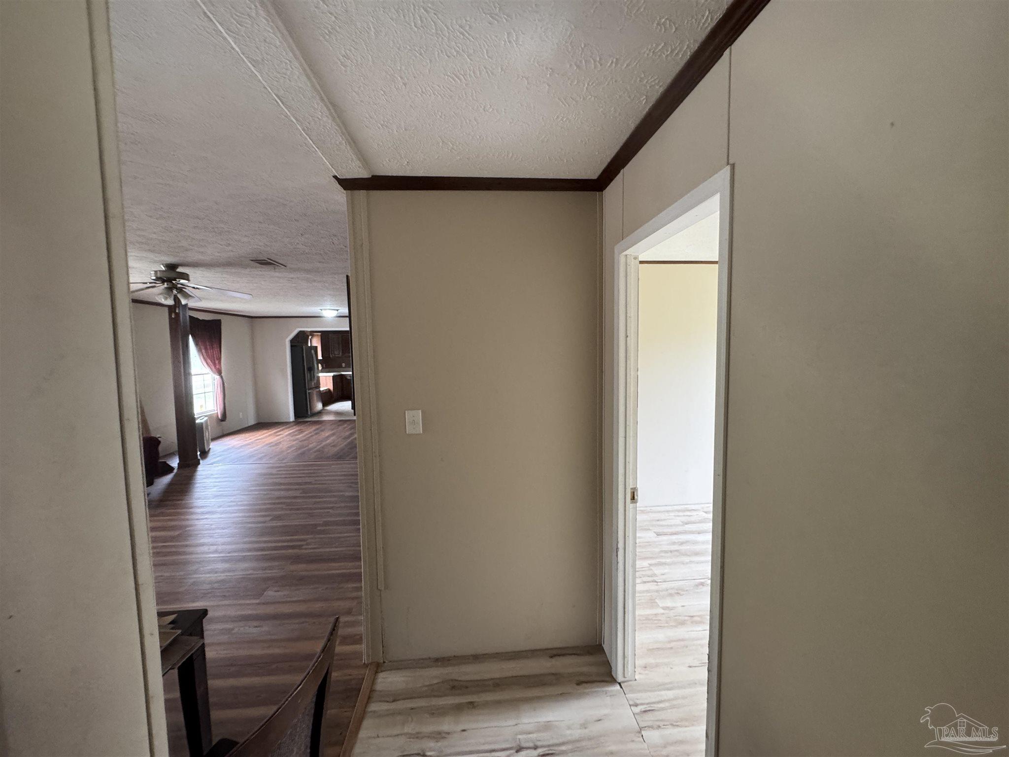4508 Farm Life Road Milton, FL 32583 - Photo 16 of 20 a view of a hallway with furniture and wooden floor