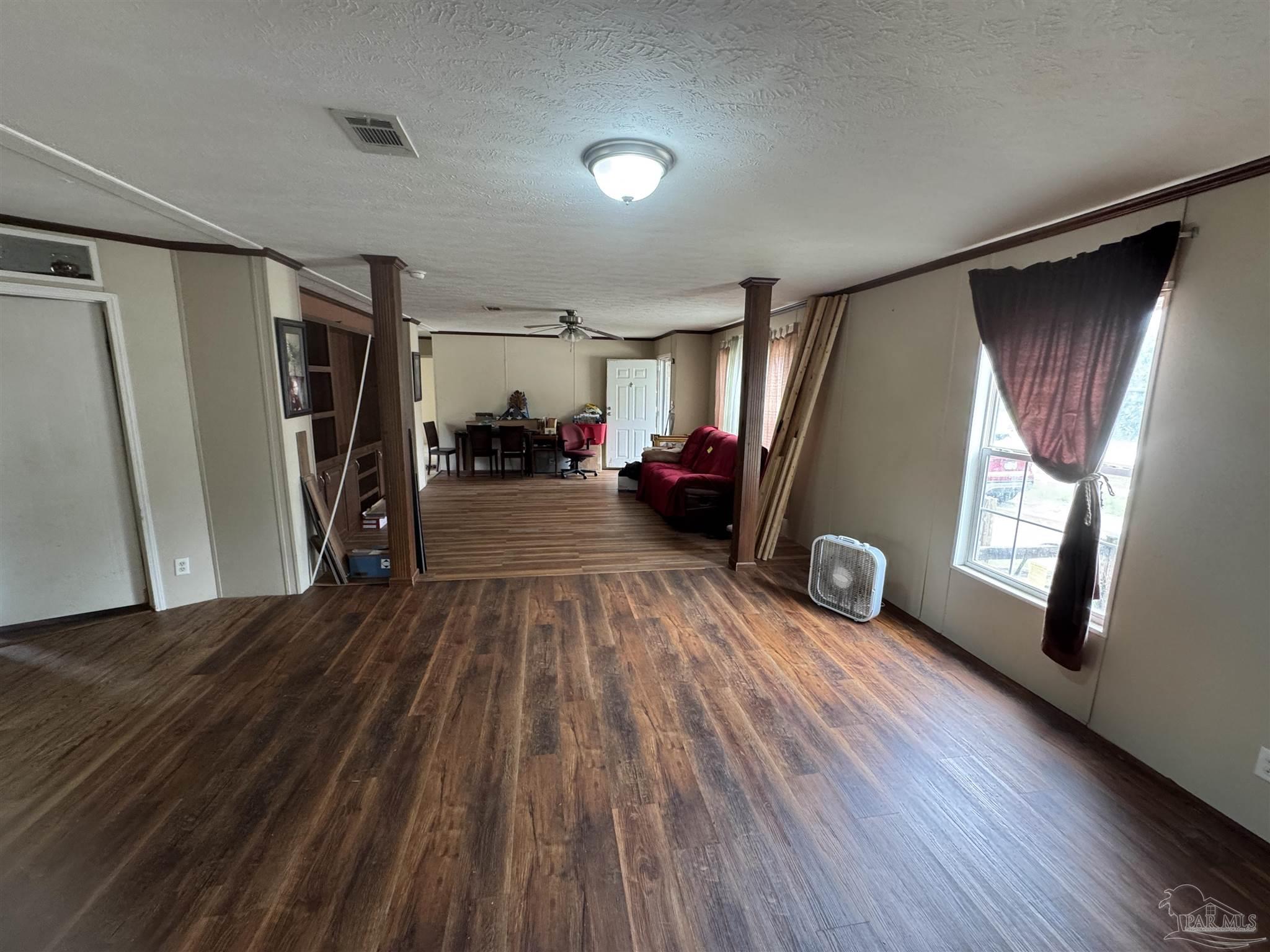 4508 Farm Life Road Milton, FL 32583 - Photo 17 of 20 a view of livingroom with hardwood floor and a ceiling fan