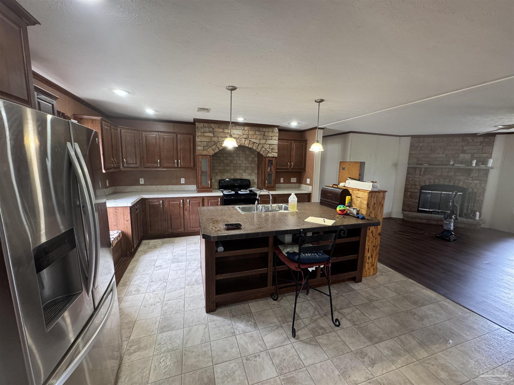4508 Farm Life Road Milton, FL 32583 - Photo 20 of 20 a kitchen with a refrigerator and a sink