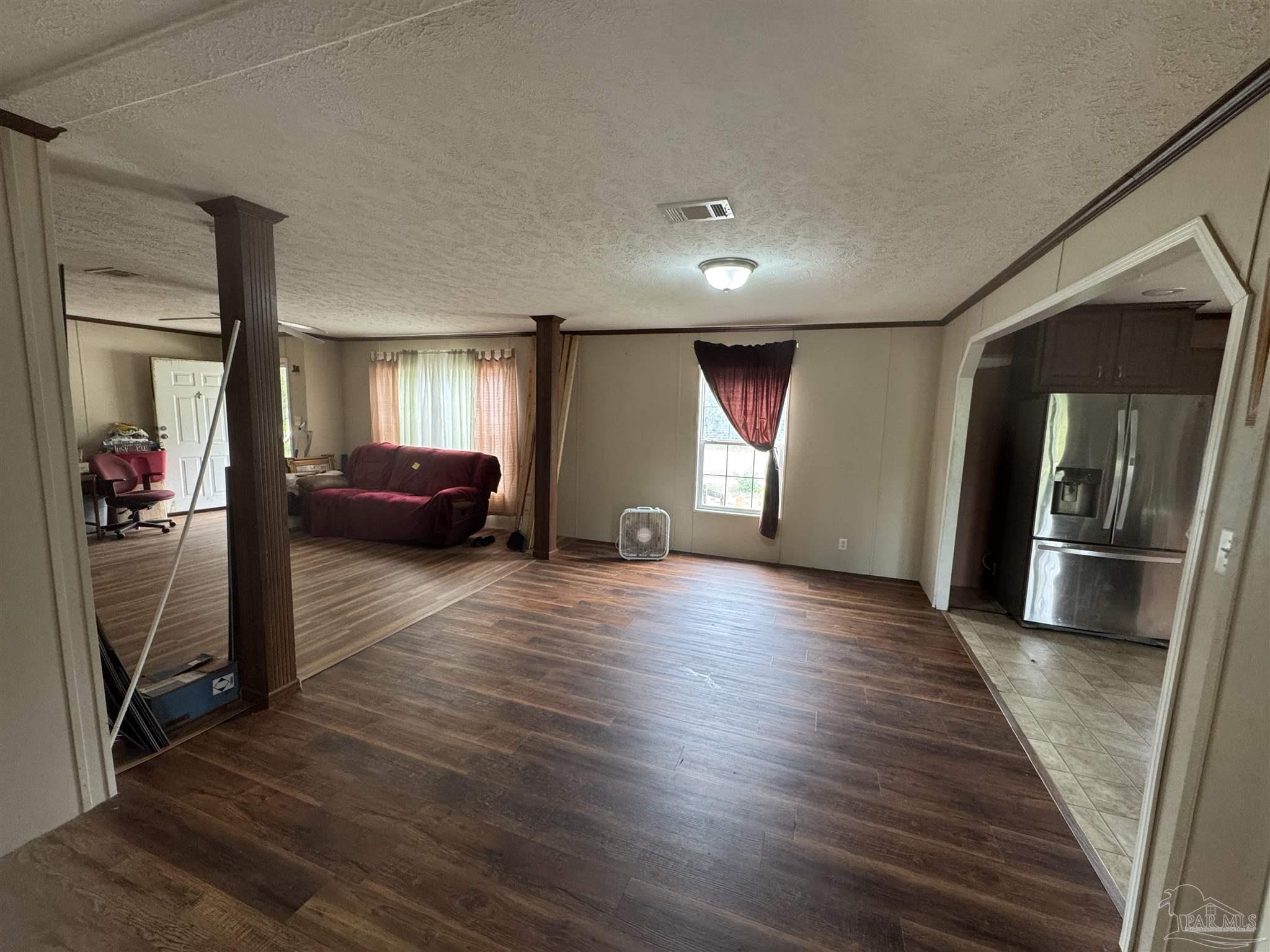 4508 Farm Life Road Milton, FL 32583 - Photo 8 of 20 a view of a livingroom with wooden floor and furniture