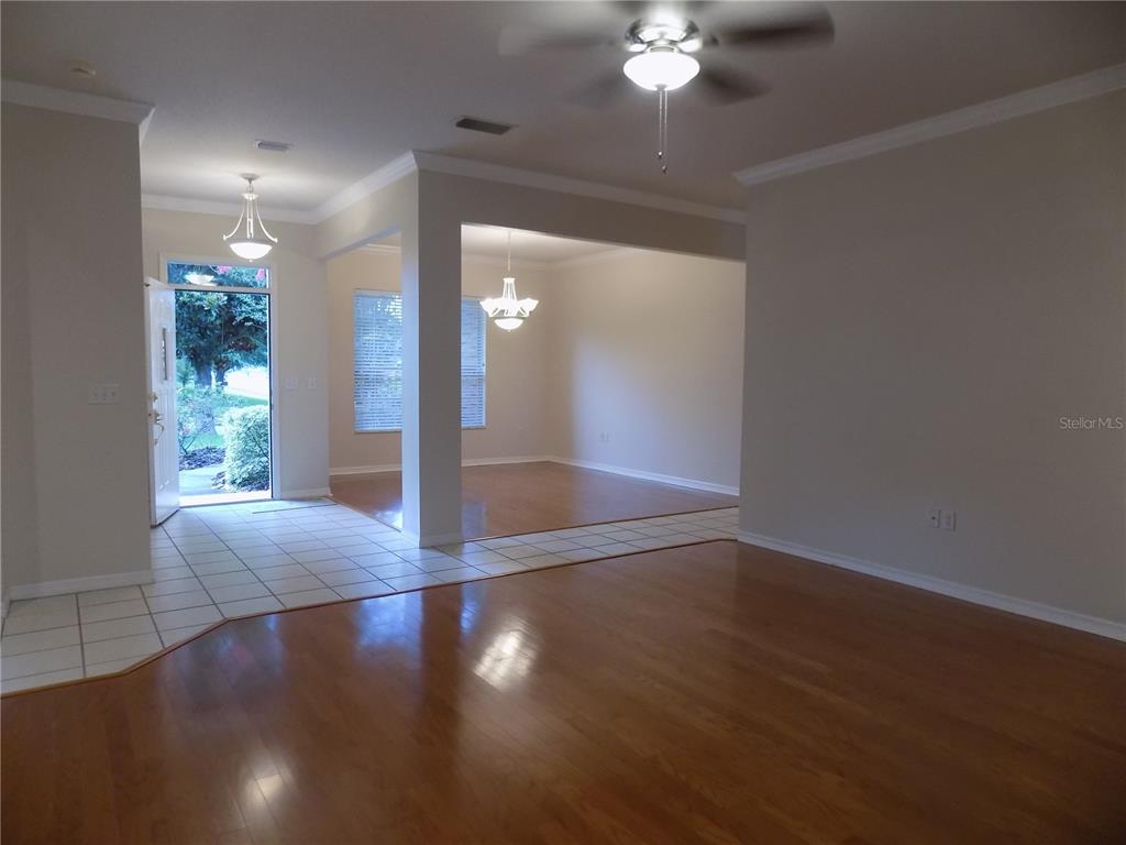 11903 Northwest 9 Road Gainesville, FL 32606 - Photo 15 of 60 an empty room with wooden floor and windows