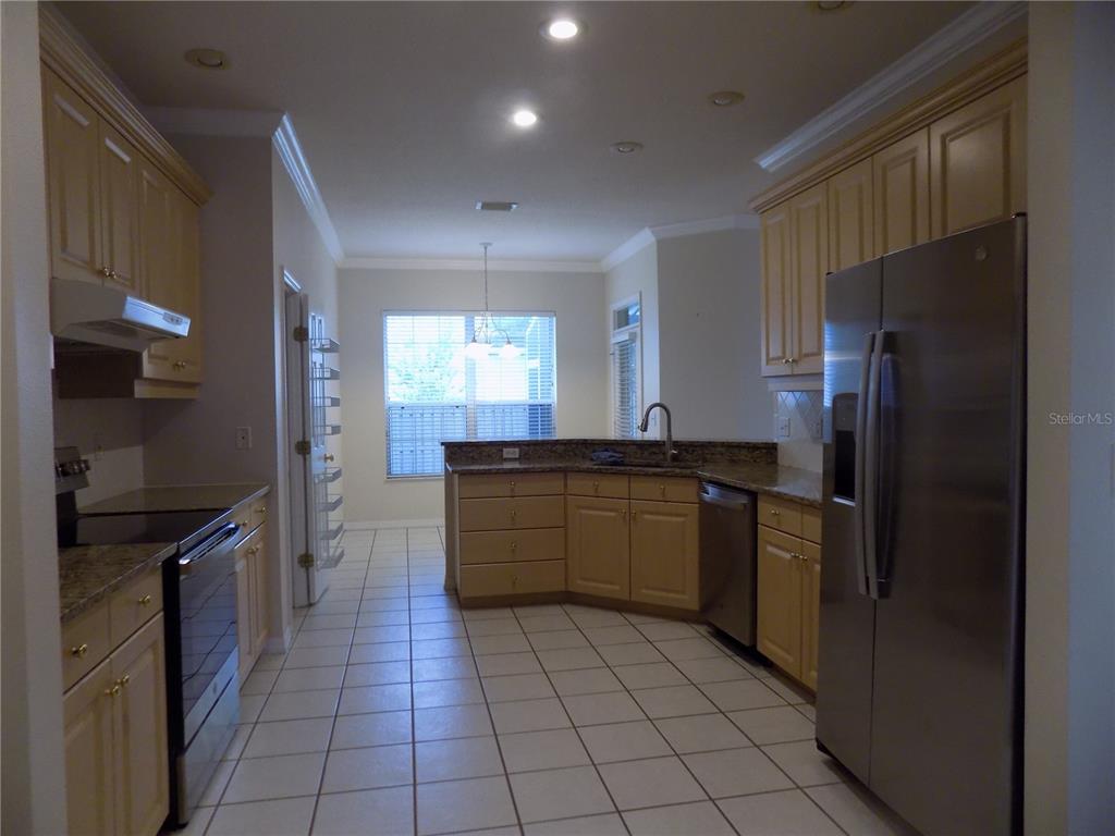 11903 Northwest 9 Road Gainesville, FL 32606 - Photo 19 of 60 a kitchen with stainless steel appliances granite countertop a refrigerator and a sink