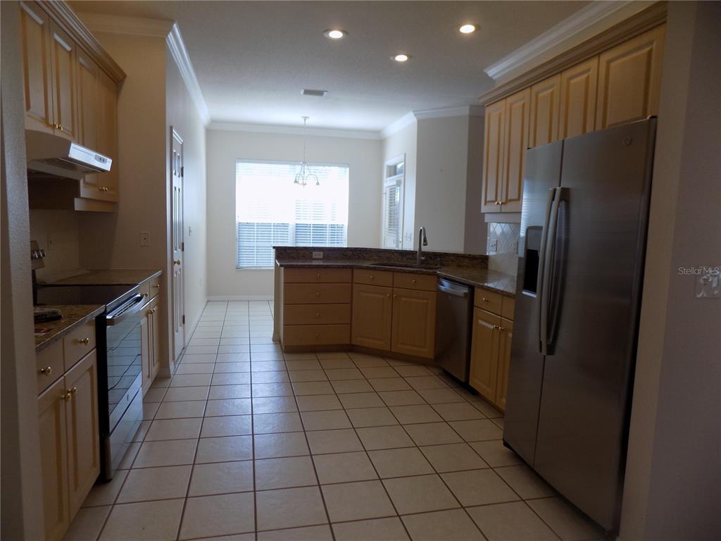 11903 Northwest 9 Road Gainesville, FL 32606 - Photo 23 of 60 a kitchen with stainless steel appliances granite countertop a refrigerator and a sink