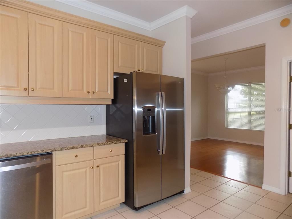 11903 Northwest 9 Road Gainesville, FL 32606 - Photo 25 of 60 a kitchen with stainless steel appliances granite countertop a refrigerator and a sink