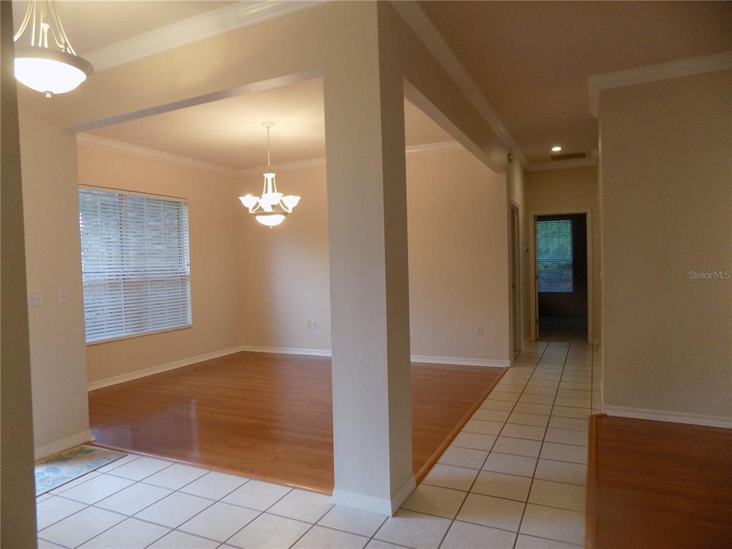 11903 Northwest 9 Road Gainesville, FL 32606 - Photo 8 of 60 a view of a hallway with wooden floor and a bathroom