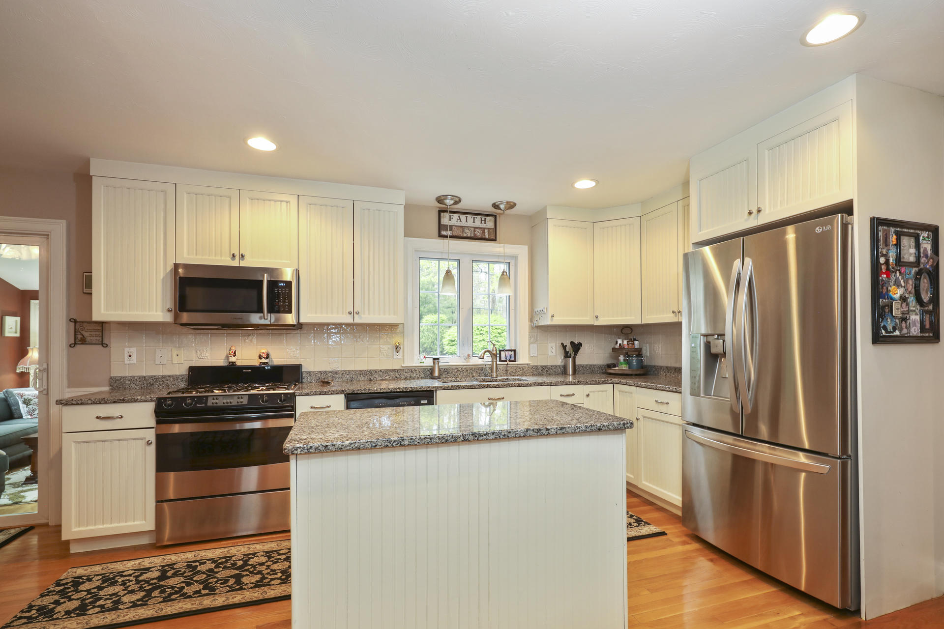 1356 Old Post Road Marstons Mills, MA 02648 - Photo 17 of 53 a kitchen with granite countertop a refrigerator stove and microwave