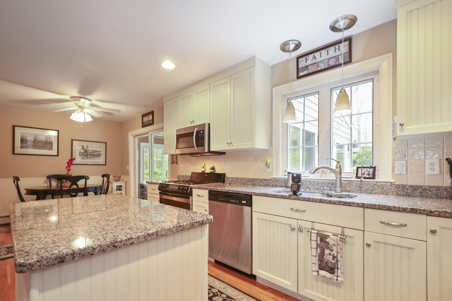 1356 Old Post Road Marstons Mills, MA 02648 - Photo 19 of 53 a kitchen with stainless steel appliances granite countertop a sink and cabinets
