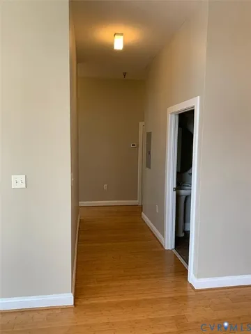 a view of hallway with wooden floor