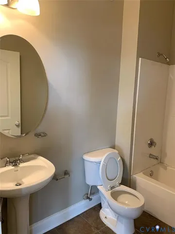 a white toilet sitting next to a bathroom sink