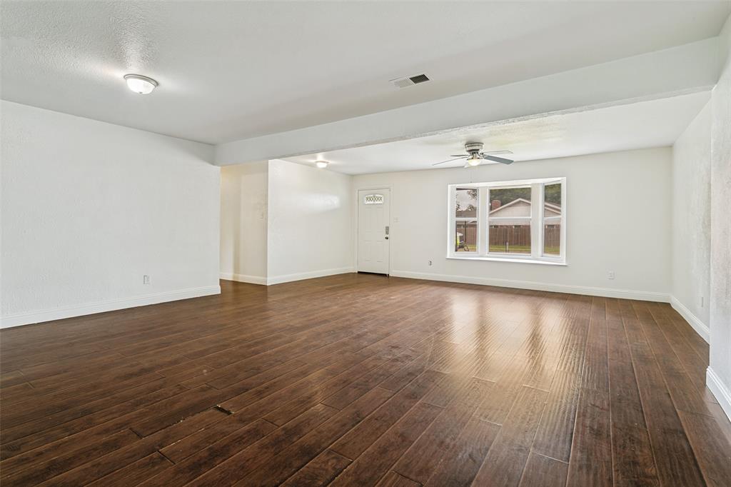 1904 Old Kirk Road Bedford, TX 76022 - Photo 5 of 25 an empty room with wooden floor and windows