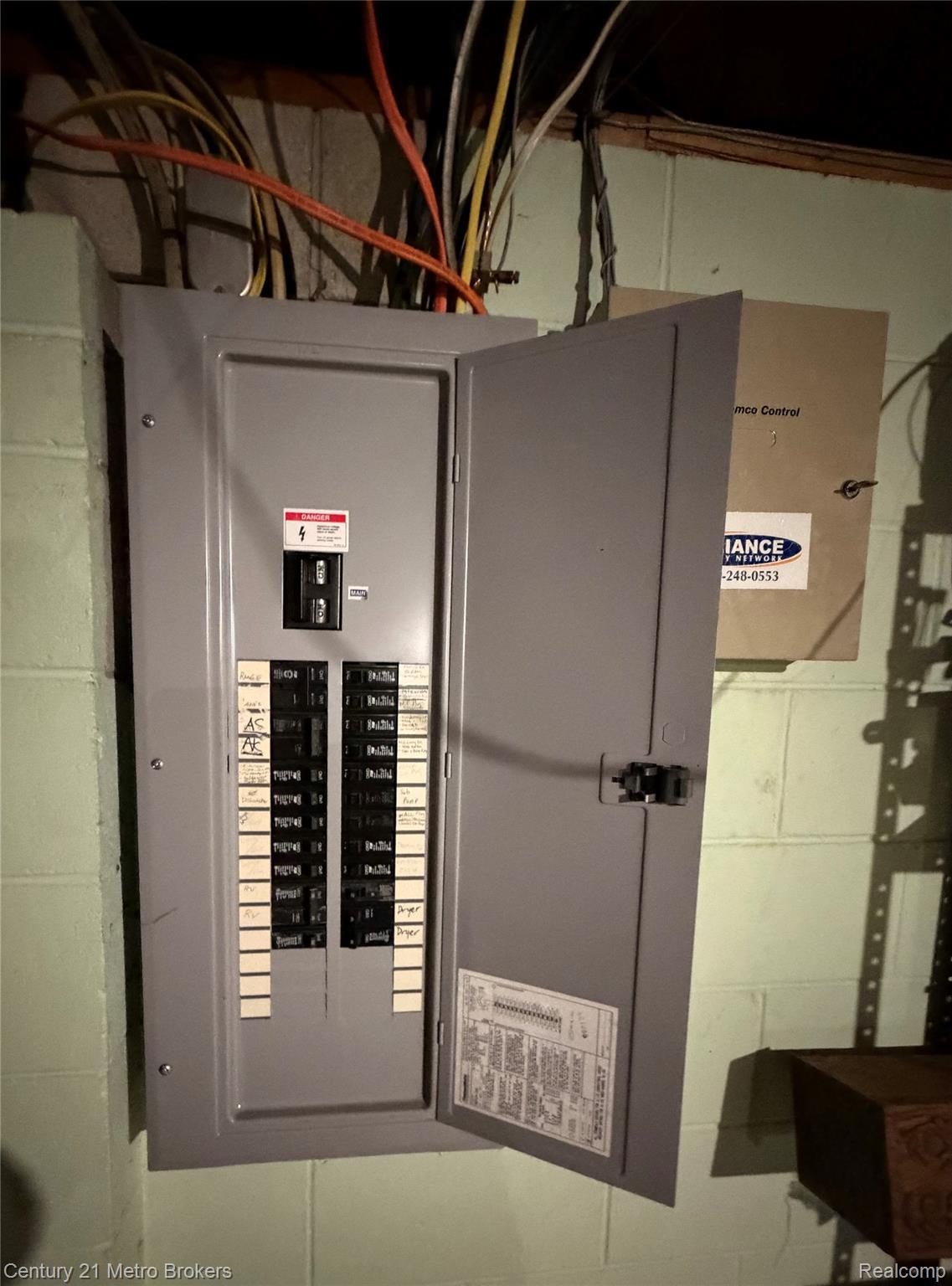 3259 North Seymour Road Flushing, MI 48433 - Photo 47 of 49 Electrical panel with an open gray metal door, exposing multiple circuit breakers