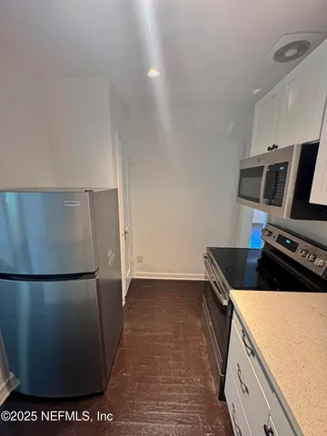 a kitchen with a sink and a refrigerator