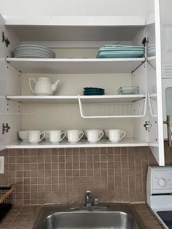 a kitchen with a sink and cabinets