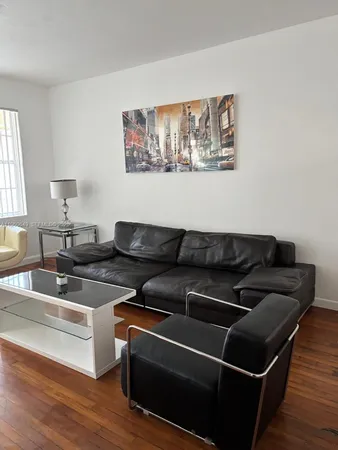 a bedroom with a bed and a wooden floor