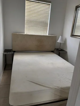 a view of a kitchen with wooden floor and a window