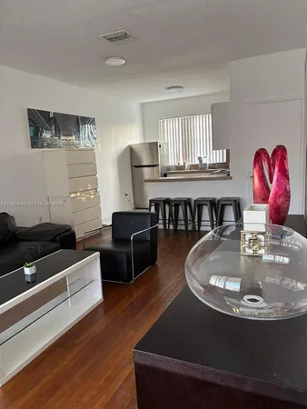 a bathroom with a granite countertop toilet a sink and a mirror