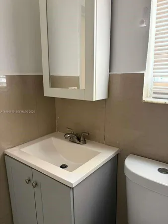 a view of a livingroom with wooden floor and cabinet