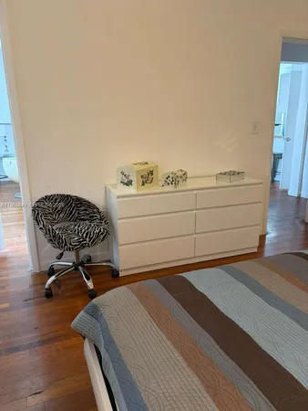 a living room with a couch and a potted plant