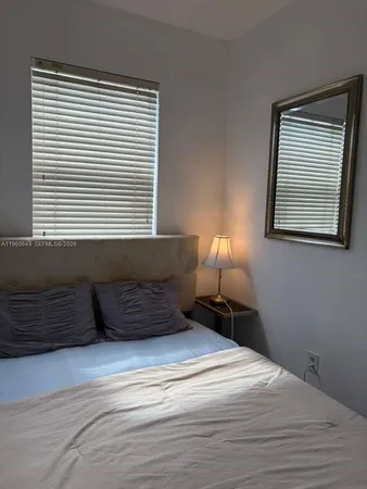 a kitchen with a table chairs sink and cabinets