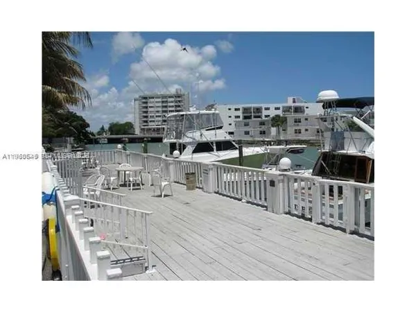 a view of a chair and table on the deck