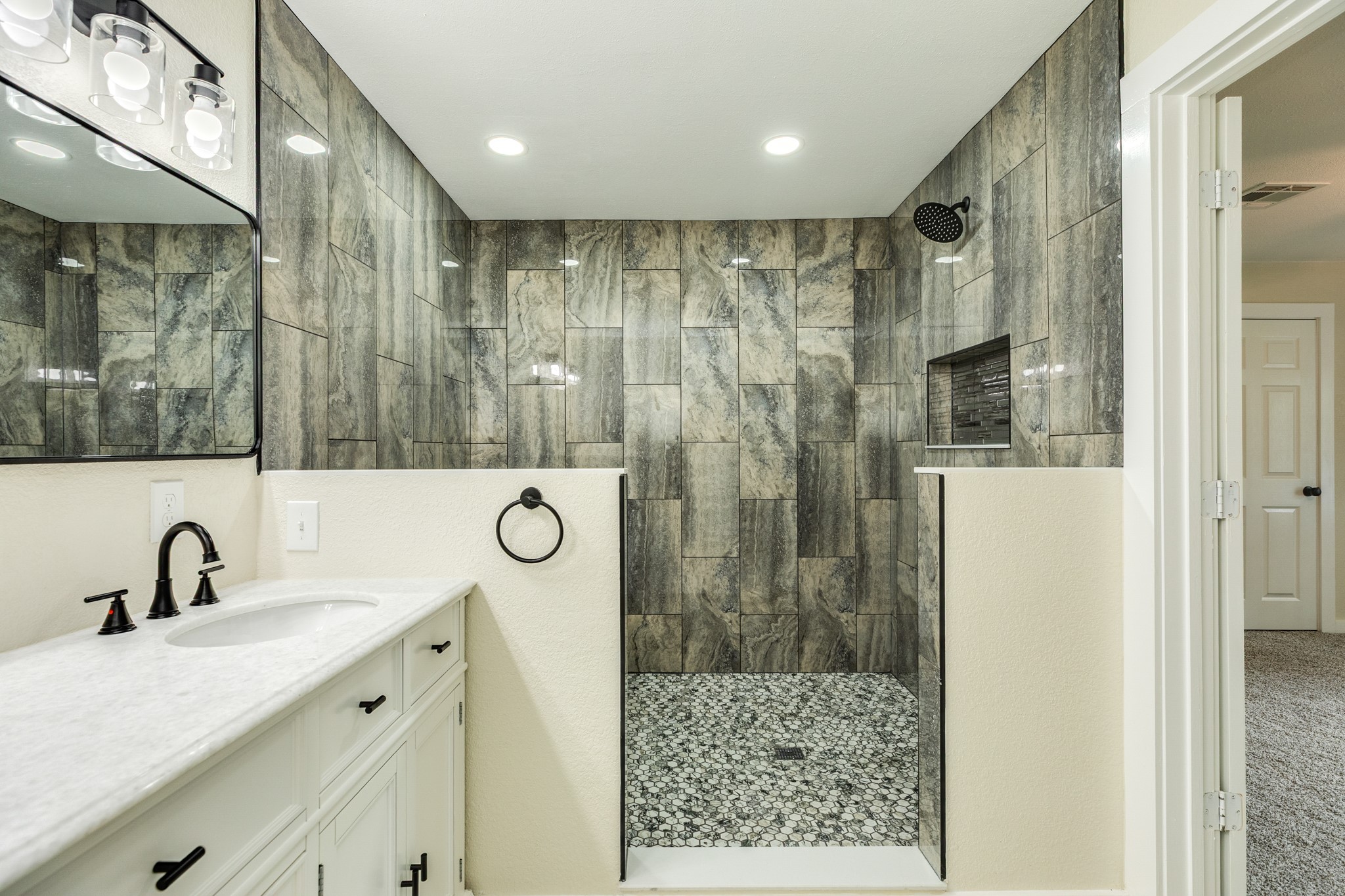 207 Stockman Street Sweeny, TX 77480 - Photo 16 of 22 a bathroom with a shower sink and mirror
