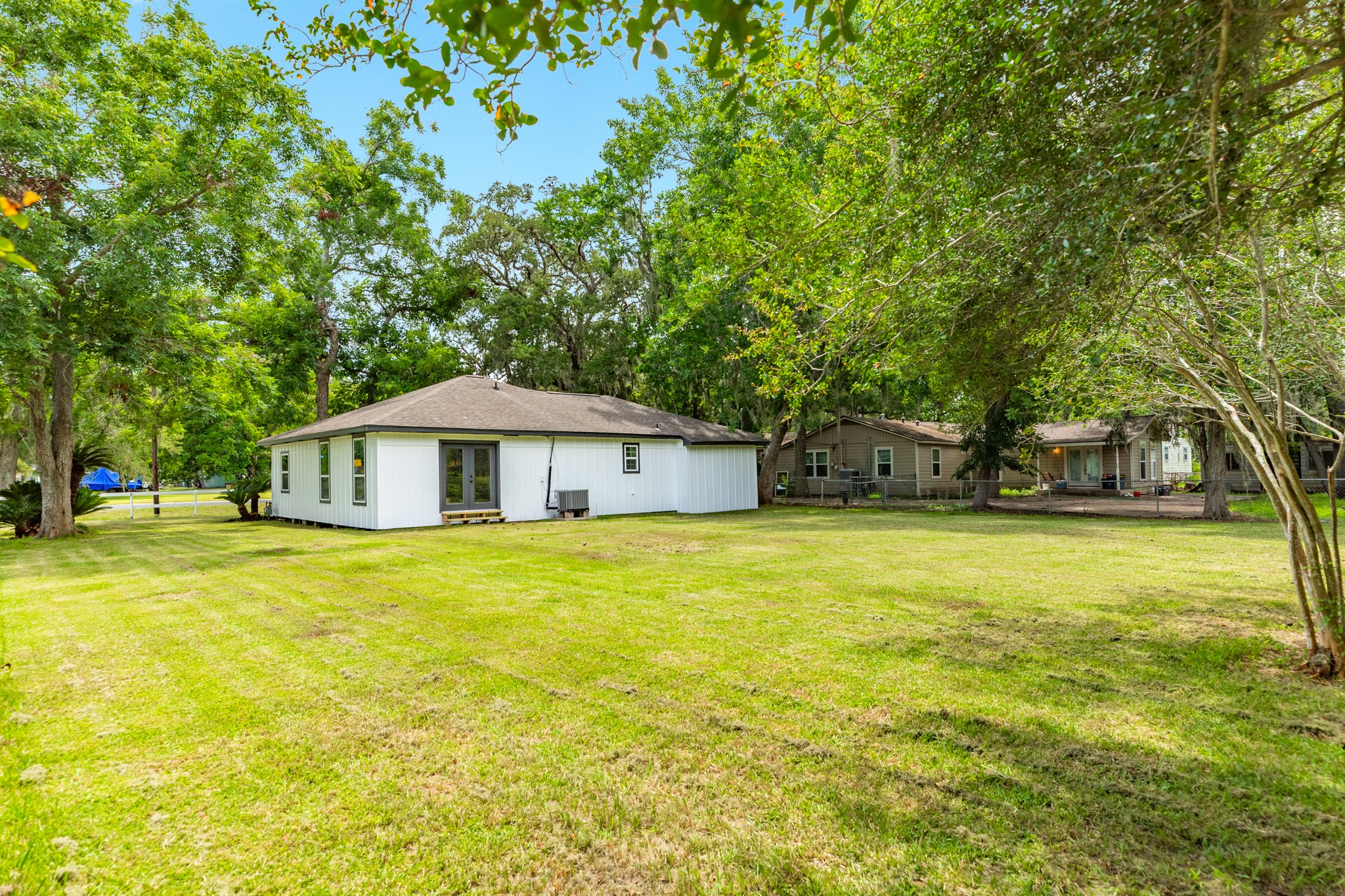 207 Stockman Street Sweeny, TX 77480 - Photo 21 of 22 a front view of a house with a yard and trees