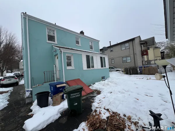 a backyard of a house with a yard and outdoor seating
