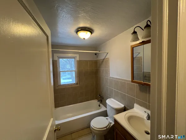 a bathroom with a toilet sink and bathtub
