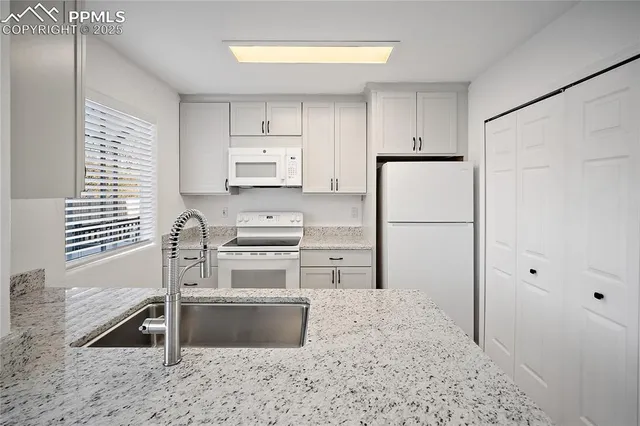 a kitchen with appliances a sink and a counter space