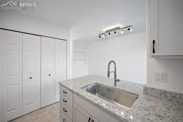 an empty room with an entryway and shower