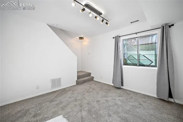 a bathroom with a sink a toilet a mirror and shower