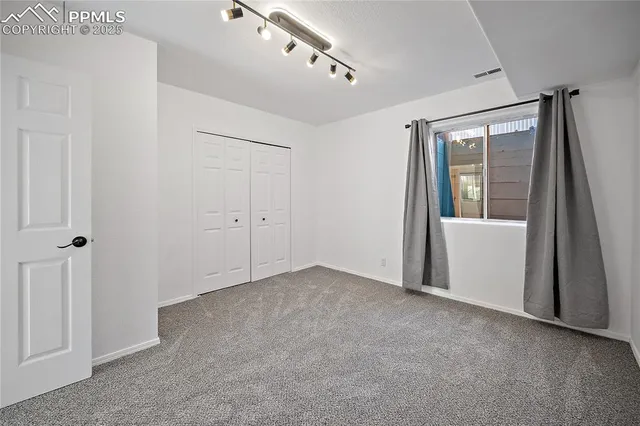 a view of a hallway with a chandelier fan