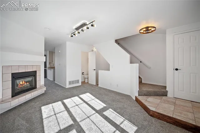 a view of a livingroom with an empty space and a fireplace