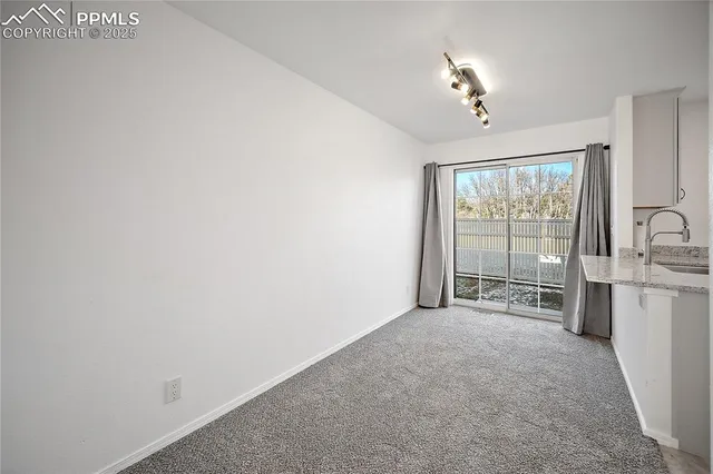 a view of a kitchen with a sink and a window