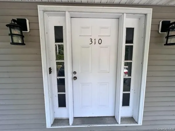 a view of front door and deck of the house