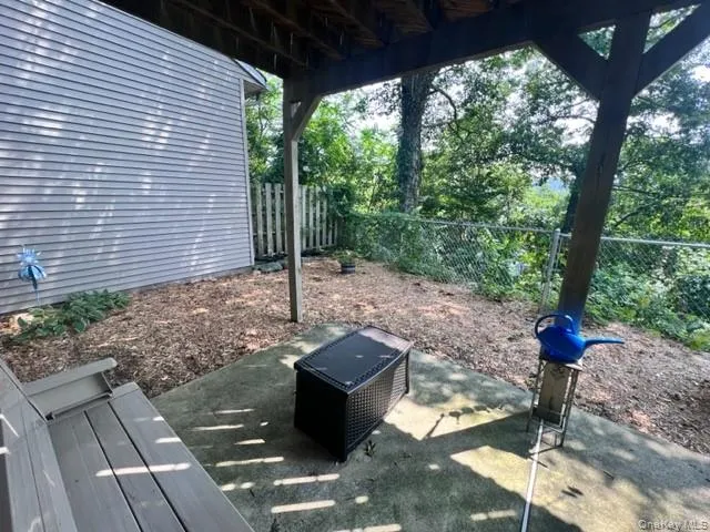 a view of a porch with furniture and a backyard