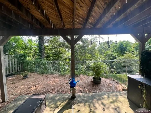 a view of a porch with furniture and yard