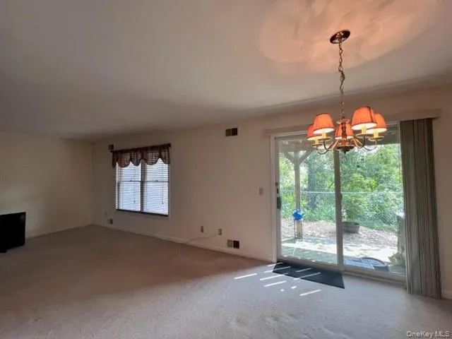 a living room with furniture and a computer on the desk