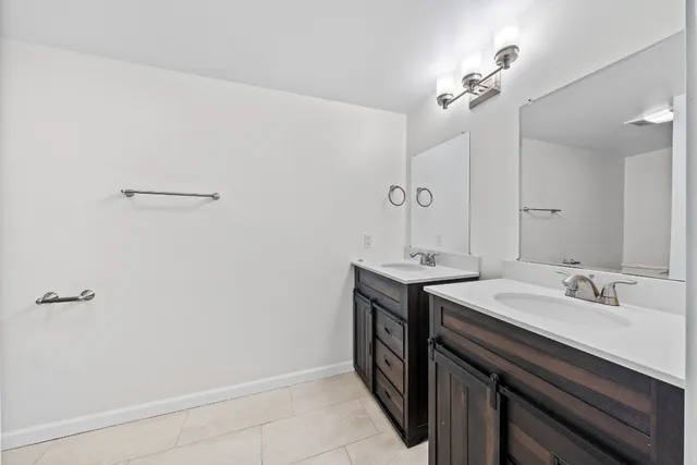 a bathroom with a sink a mirror and a vanity