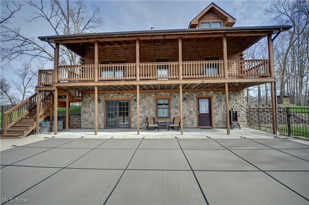 8045 McFadden Road Shreve, OH 44676 - Photo 17 of 45 Back of property featuring log exterior, stone siding, a patio, and a wooden deck