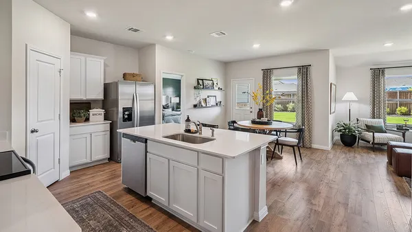 a kitchen with sink cabinets and refrigerator