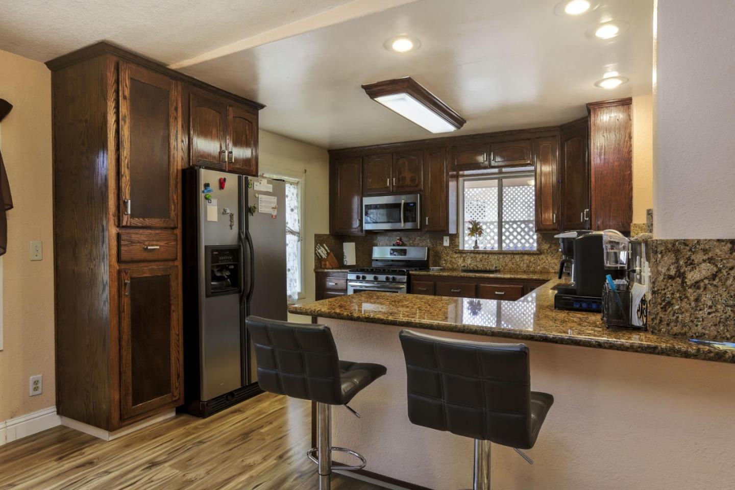 746 Echo Valley Road Salinas, CA 93907 - Photo 11 of 54 a kitchen with stainless steel appliances granite countertop a refrigerator and a stove