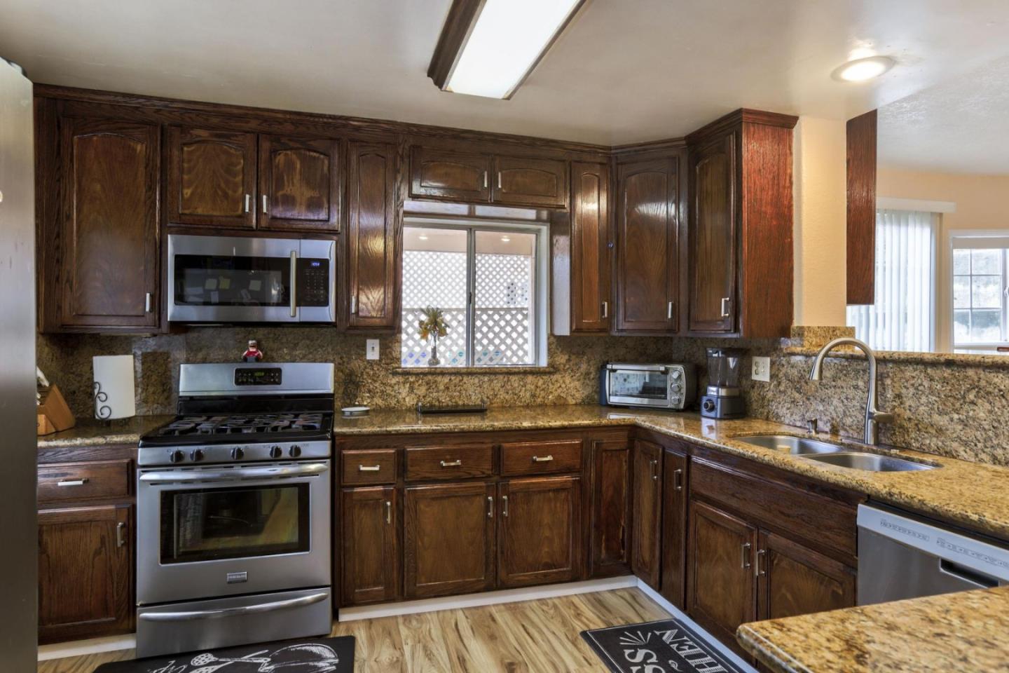 746 Echo Valley Road Salinas, CA 93907 - Photo 13 of 54 a kitchen with stainless steel appliances a stove sink microwave and cabinets