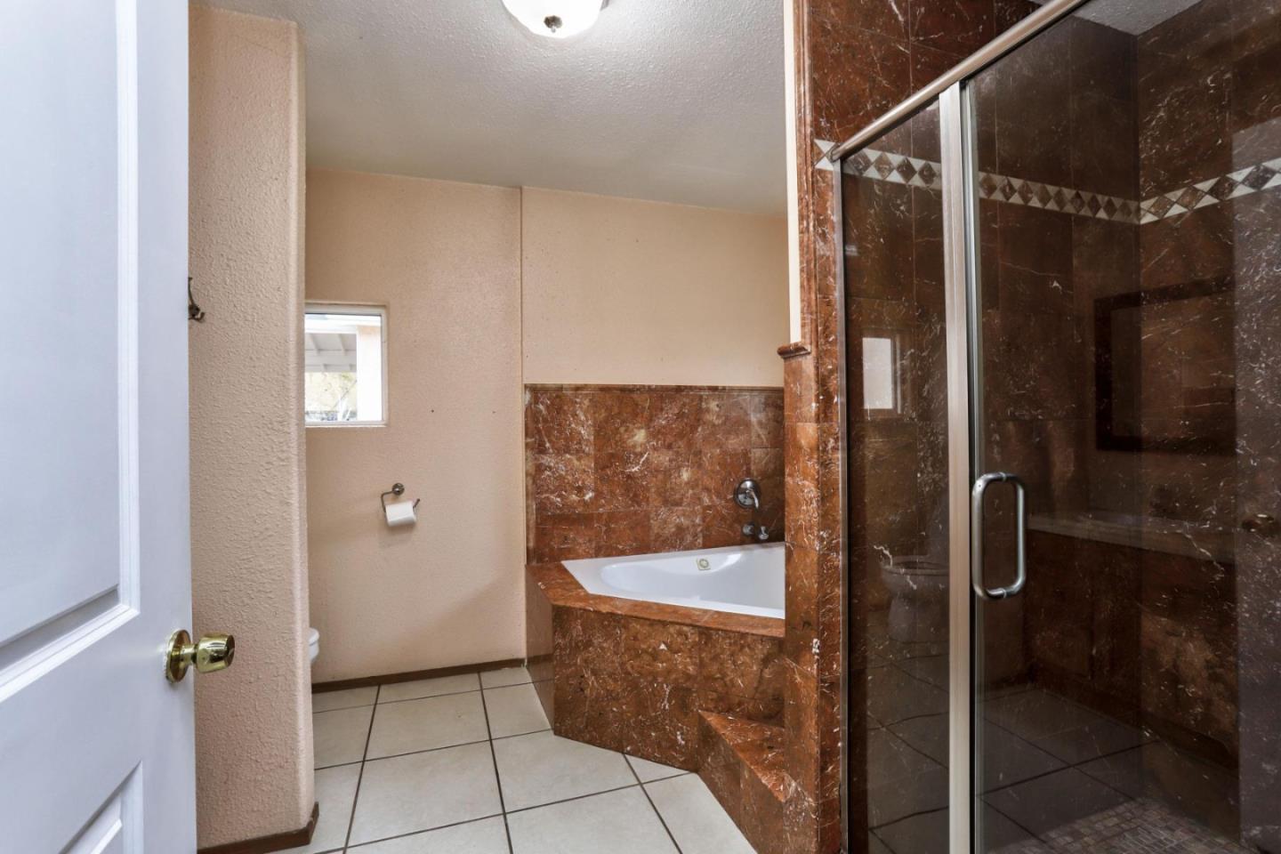 746 Echo Valley Road Salinas, CA 93907 - Photo 24 of 54 a bathroom with a glass shower door