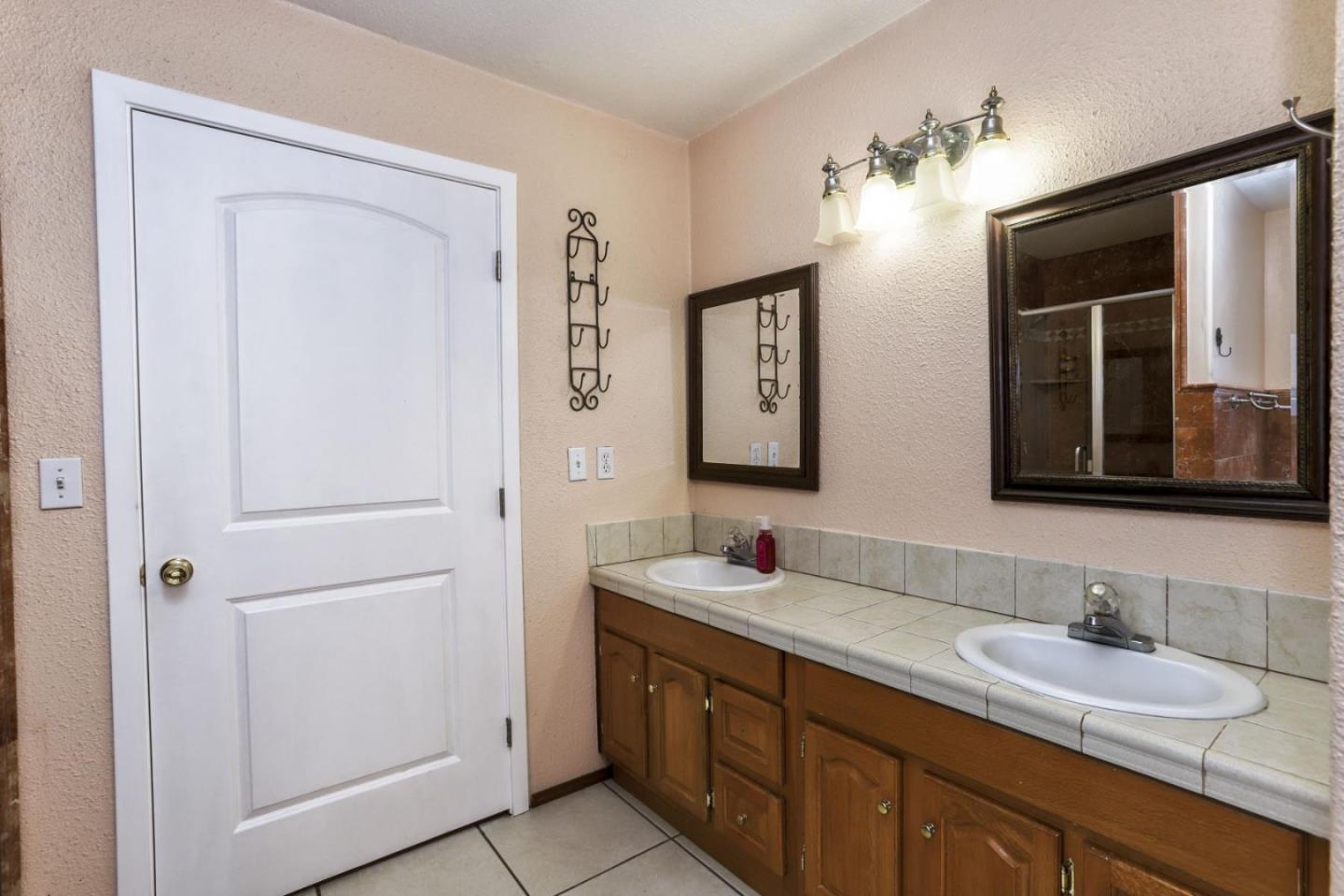 746 Echo Valley Road Salinas, CA 93907 - Photo 25 of 54 a bathroom with a double vanity sink and a mirror