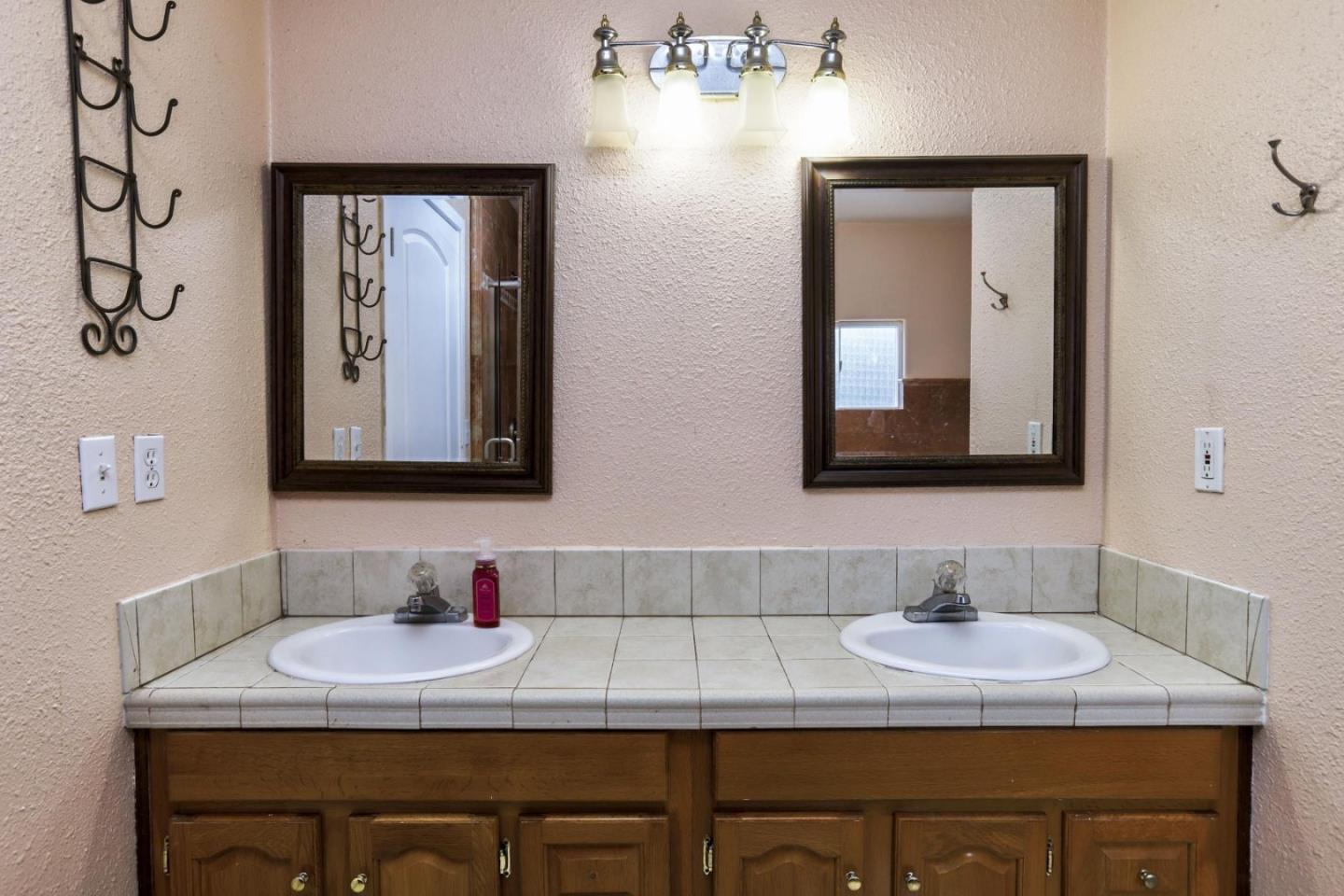 746 Echo Valley Road Salinas, CA 93907 - Photo 27 of 54 a bathroom with double vanity sinks and a mirror